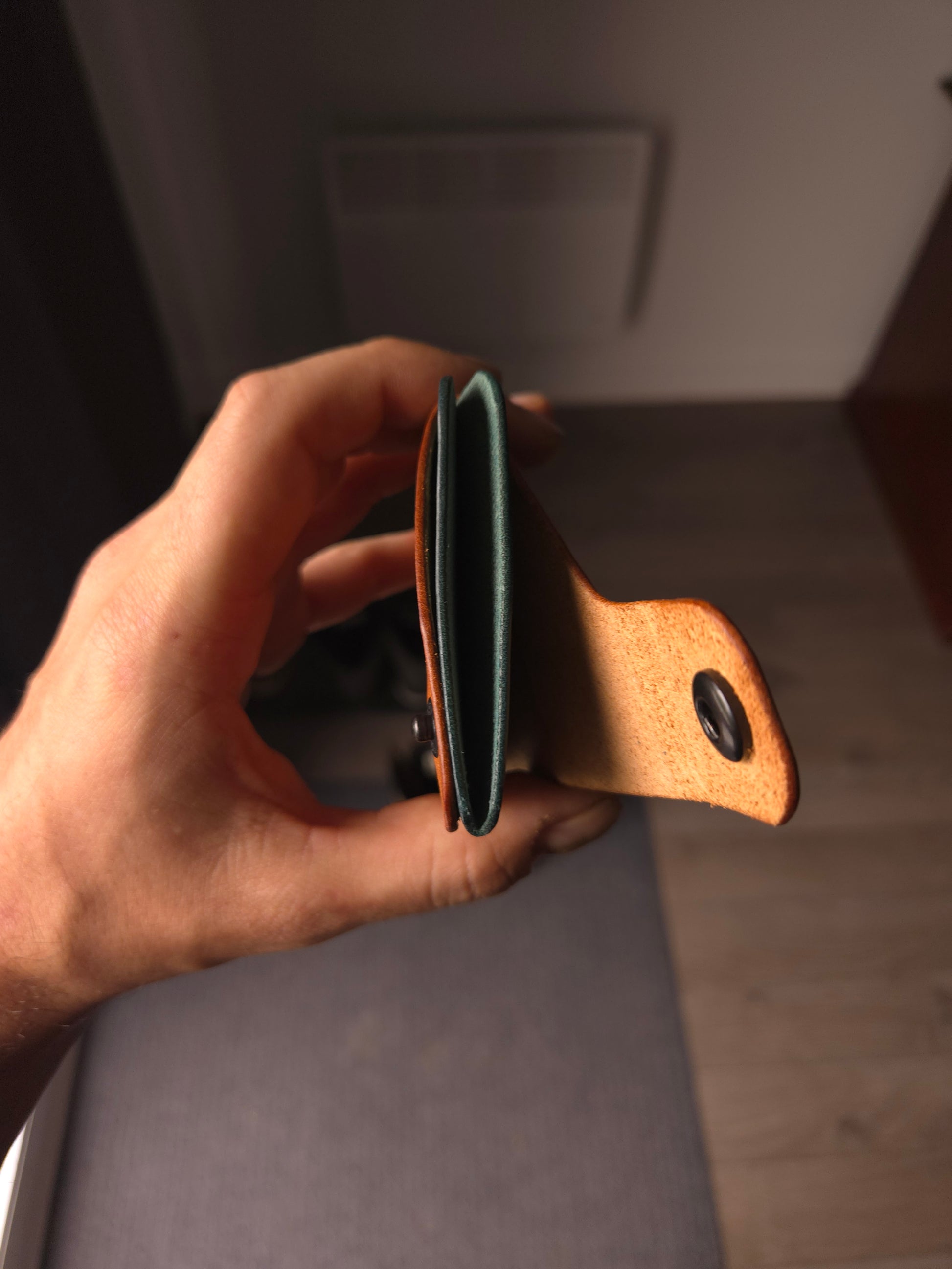Le Patron wallet showing card slots and cash compartment. colors are cognac & aqua.
