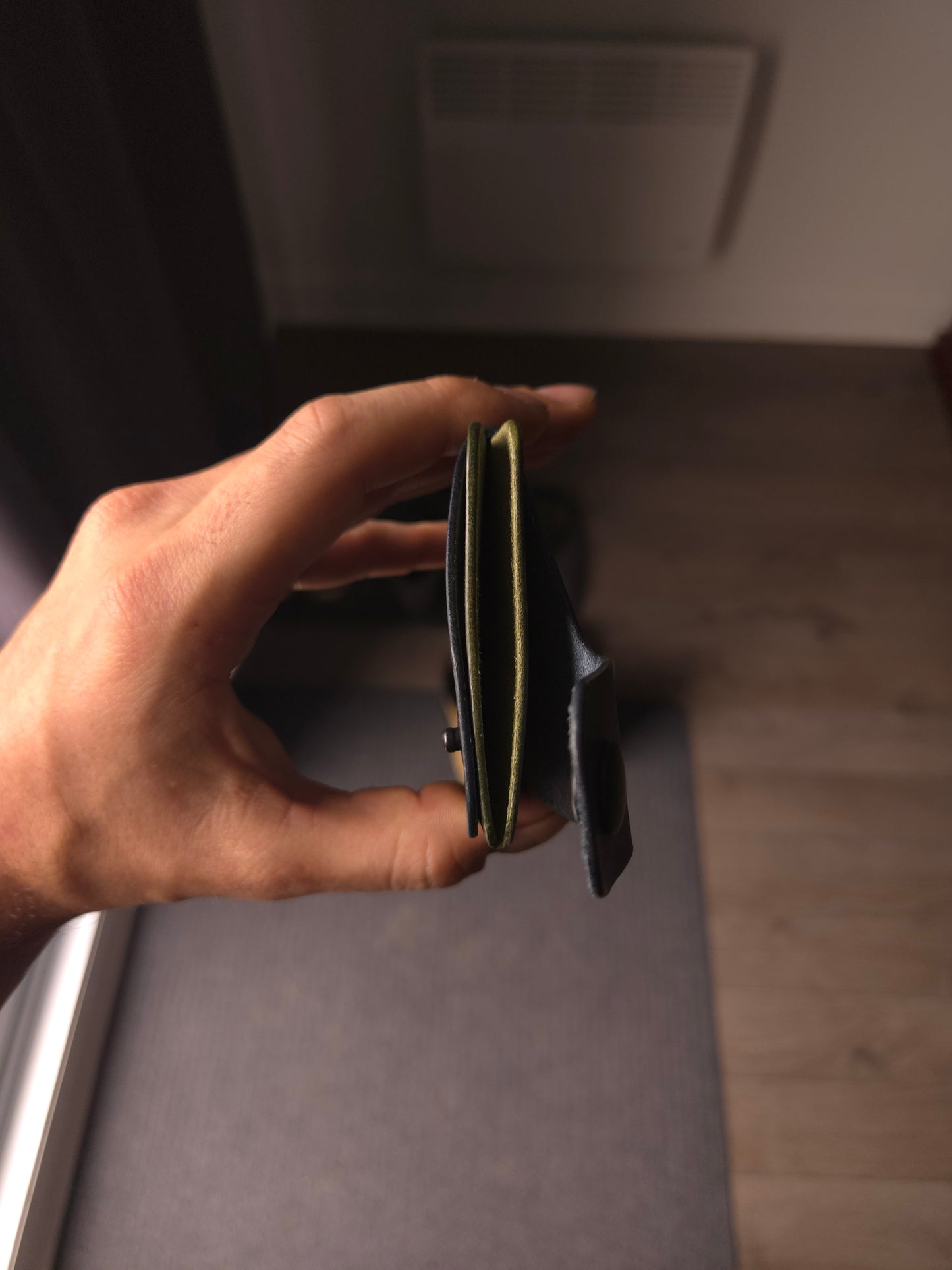 Le Patron wallet showing card slots and cash compartment. colors are navy & olive.